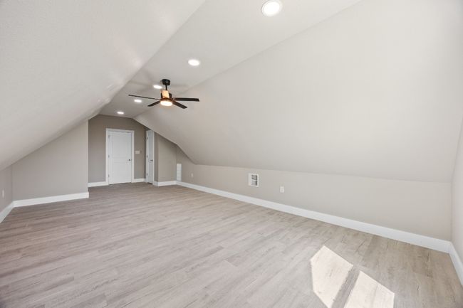Bonus room featuring baseboards, recessed lighting, light wood-style flooring, visible vents, and lofted ceiling | Image 19