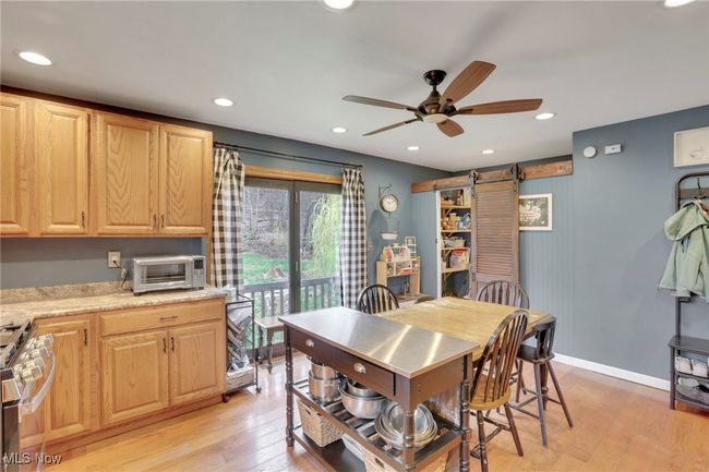 Dining space with ceiling fan, light wood finished floors, and recessed lighting | Image 14
