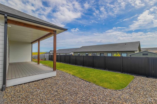 Fenced backyard with a wooden deck and a residential view | Image 32