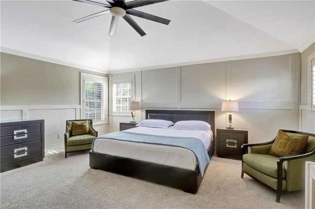 Carpeted bedroom featuring ornamental molding, a ceiling fan, vaulted ceiling, and a decorative wall | Image 8
