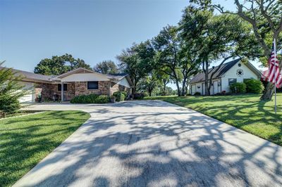 View of front of house featuring a garage and a front lawn | Image 1