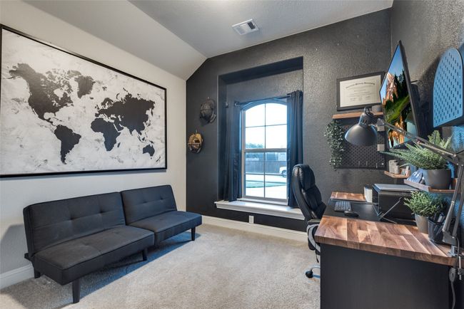 Carpeted office featuring baseboards, vaulted ceiling, visible vents, and a textured wall | Image 20