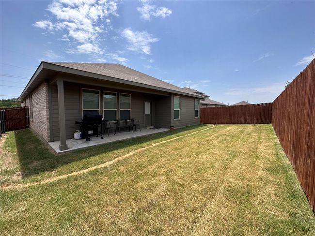 Back of house with a fenced backyard, a patio, and roof with shingles | Image 14