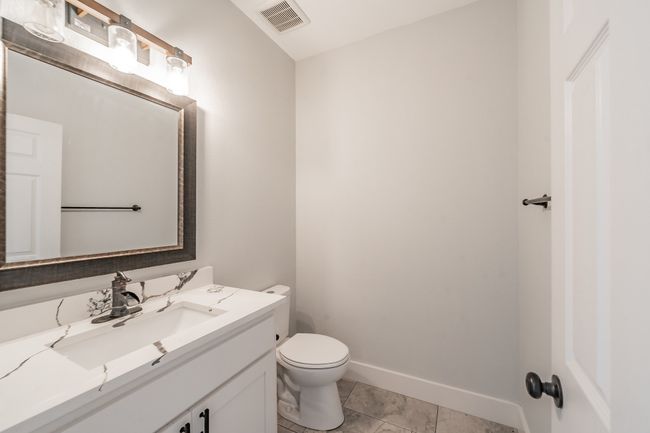 Bathroom featuring toilet, vanity, baseboards, and tile patterned floors | Image 36