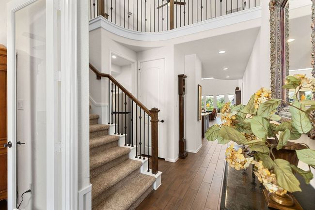 Entrance foyer featuring dark wood finished floors, stairway, and recessed lighting | Image 4