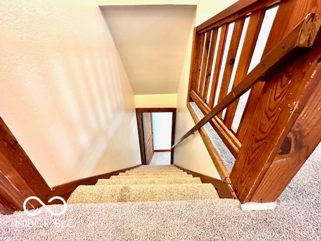 stairs featuring baseboards and carpet | Image 12