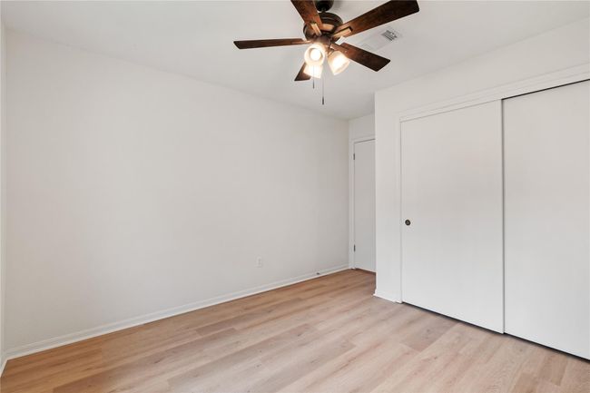 Alternate view of third bedroom showing double closet and clean finishes. | Image 23