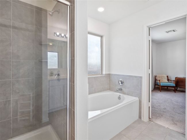 Ensuite bathroom with tile patterned floors, a garden tub, and a stand alone shower. | Image 11