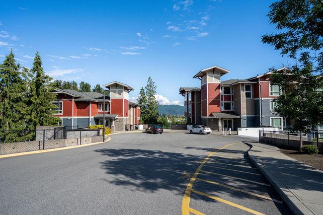 View of asphalt street featuring a residential view, sidewalks, and curbs | Image 4