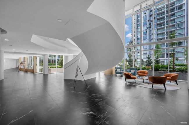 Building lobby featuring a wall of windows and a high ceiling | Image 27