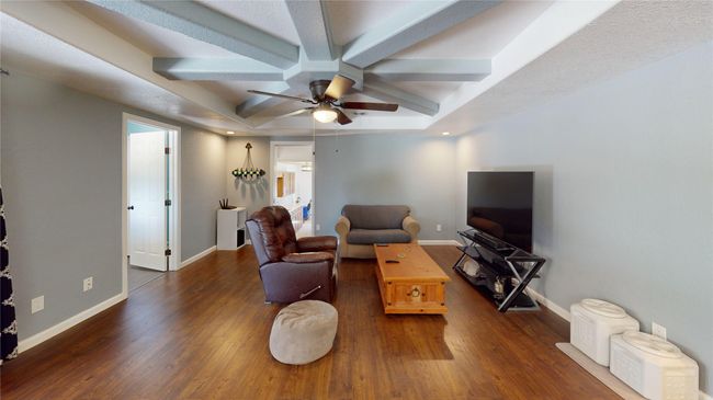 Living room with wood finished floors and a ceiling fan | Image 6