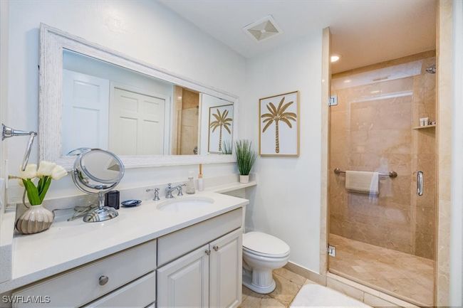 Primary Bathroom with toilet, vanity, an enclosed shower with frameless door (Primary walk in closet and lock out owners closet not shown) | Image 13