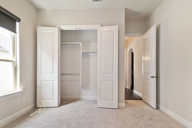 Unfurnished bedroom featuring multiple windows, a closet, and carpet | Image 9