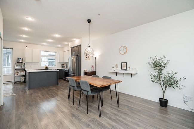 Dining room featuring dark wood-style floors, a baseboard heating unit, and baseboards | Image 9
