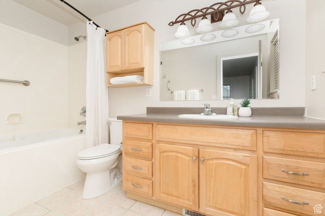 Bathroom featuring tile patterned floors, vanity, and shower / tub combo with curtain | Image 12