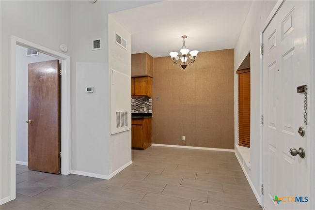 Front entry door to the right with the bedroom to the left and dining/breakfast nook straight ahead. | Image 6