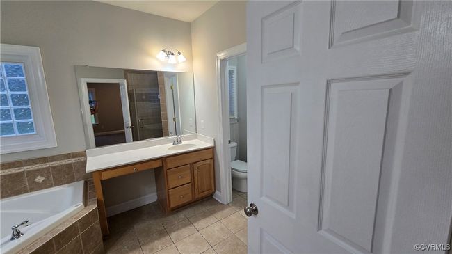First Floor Bathroom with toilet, vanity, tile patterned flooring, tiled shower, and a bath | Image 28
