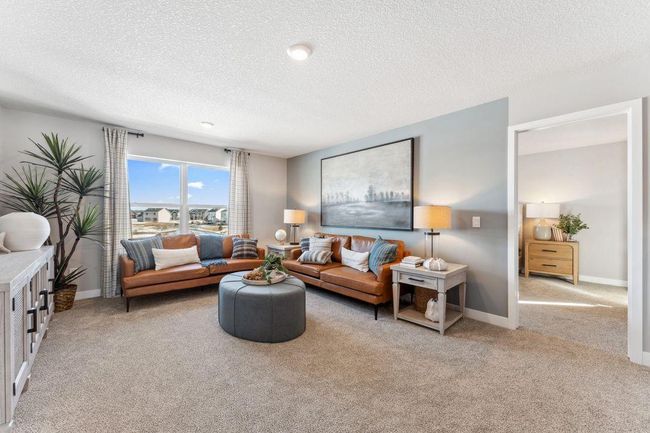 Another view of the second floor loft. Note the entry to a secondary suite. Photo of model home, colors and finishes will vary. | Image 20