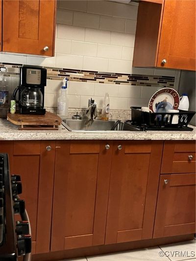 Kitchen with backsplash, sink, and light tile patterned flooring | Image 3