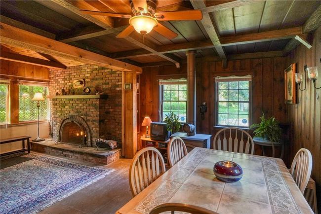 Dining room featuring wooden walls, beamed ceiling, and wood ceiling | Image 10