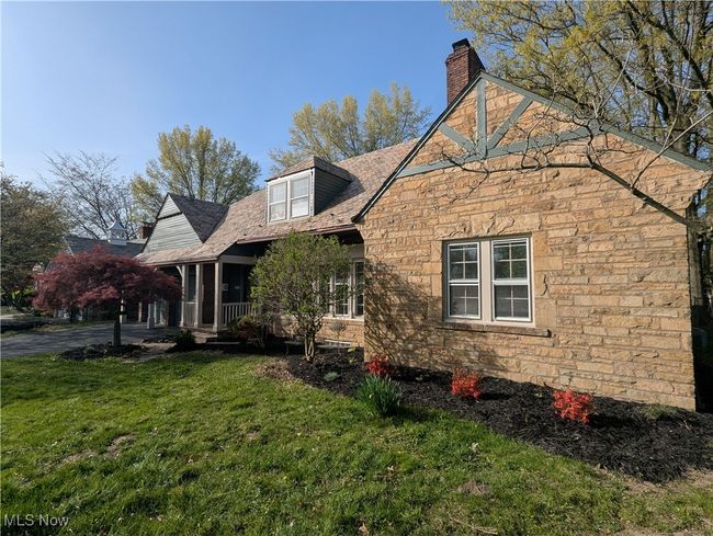 View of side of property featuring a chimney, a yard, and stone siding | Image 17