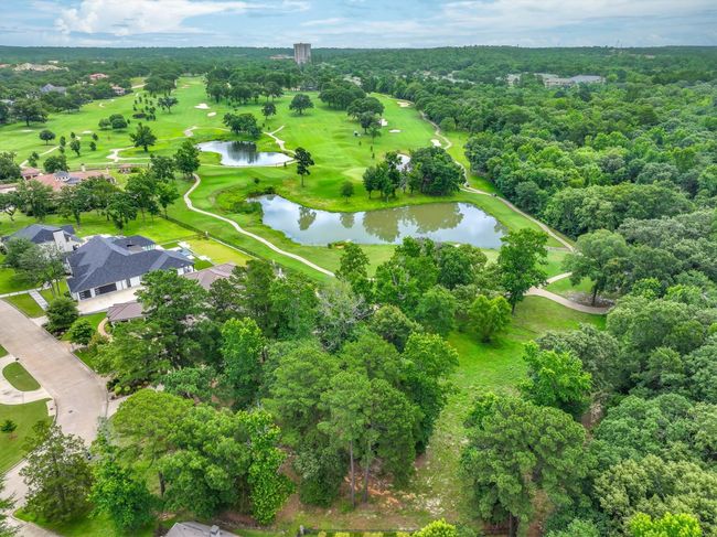 Drone / aerial view of a nearby body of water and a local golf course | Image 4