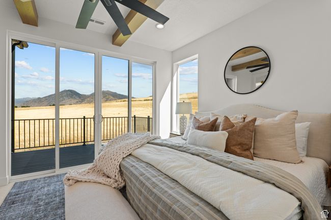 Bedroom featuring a mountain view, beam ceiling, access to outside, and recessed lighting | Image 42