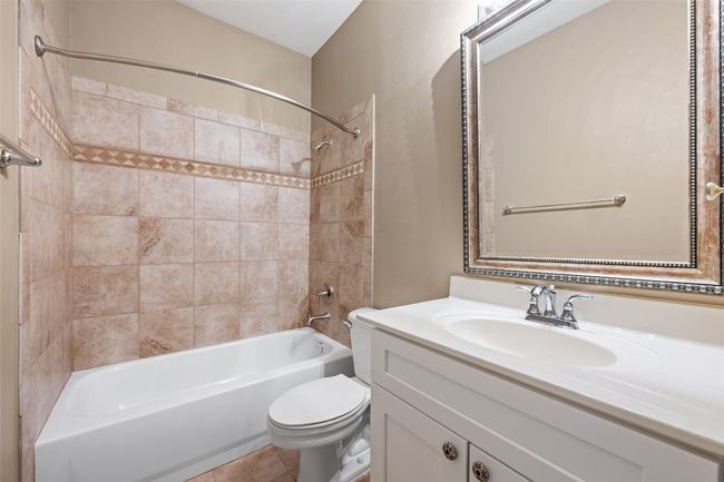 Secondary Bathroom with toilet, tile patterned floors, vanity, and shower / bathing tub combination | Image 27