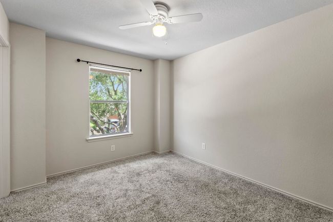 Another nice-sized bedroom with a ceiling fan and a walk-in closet. | Image 23