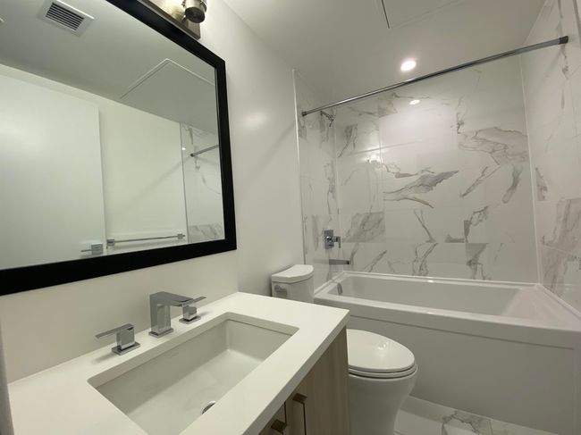 Full bath with marble finish floor, visible vents, toilet, vanity, and tub / shower combination | Image 6