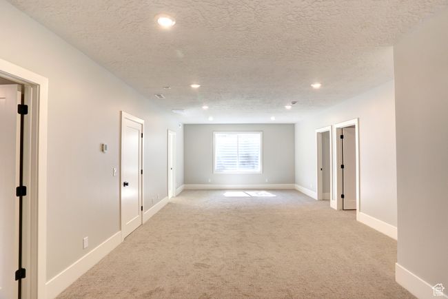 Spare room with light carpet, recessed lighting, and a textured ceiling | Image 32