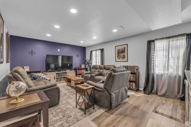 Living area with light wood-style floors, and recessed lighting | Image 22
