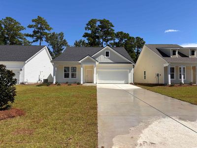 View of front of house featuring a front lawn, a garage, and a porch | Image 1