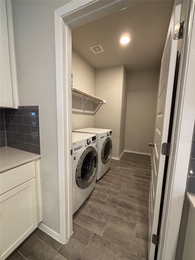 Laundry room with baseboards, independent washer and dryer, dark wood finished floors, and recessed lighting | Image 13