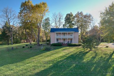 View of front of house featuring a balcony and a front lawn | Image 1