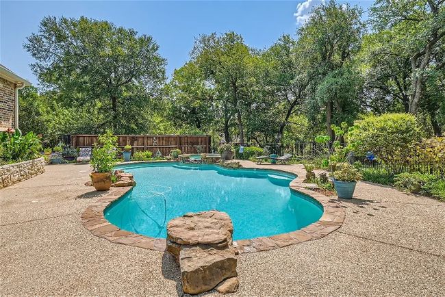 View of swimming pool with a patio, fence, and a fenced in pool | Image 31