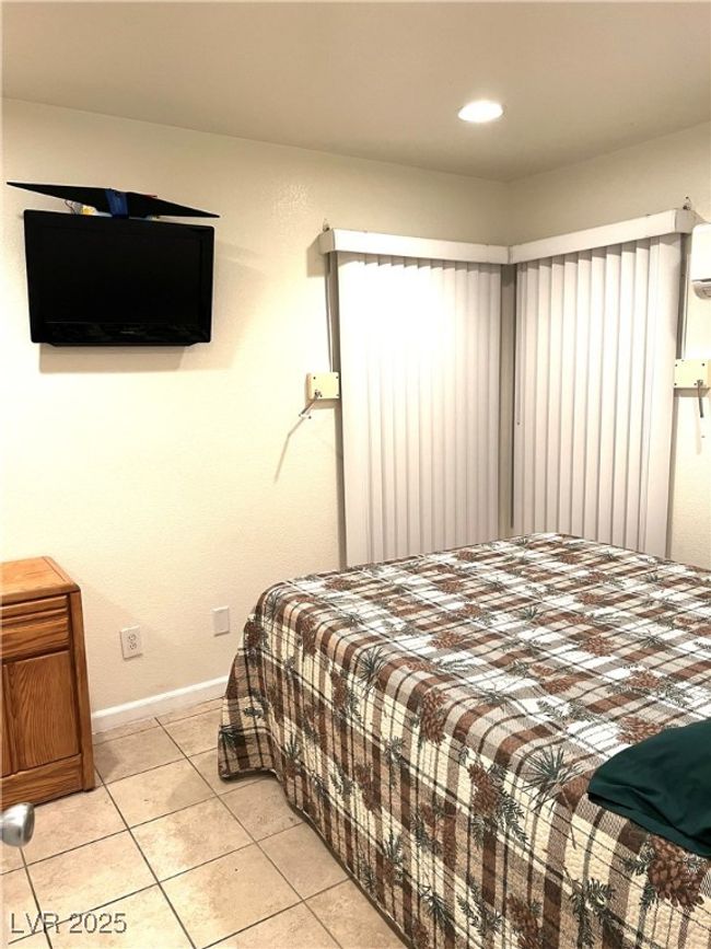 Bedroom with light tile patterned flooring and baseboards | Image 21