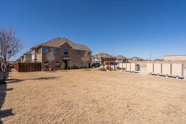 View of yard featuring a pergola, a residential view, and fence | Image 27