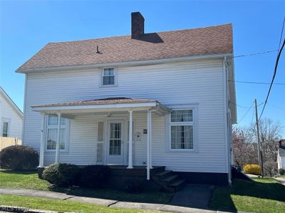 View of front of house featuring a front lawn and a porch | Image 1