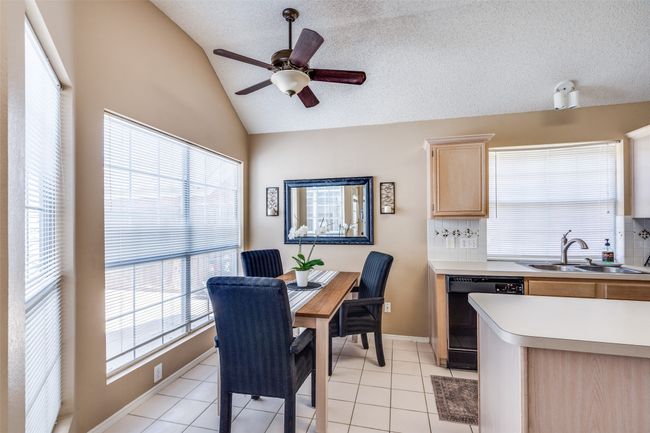 Plenty of natural light floods the breakfast and kitchen areas with a charming view of the courtyard-style patio. | Image 11