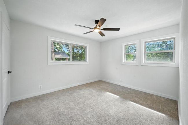 In Law Suite is a large bedroom with two separate closets, lots of windows for natural lighting and a full bathroom just a few steps away. | Image 12