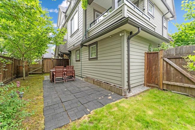 View of side of home with a gate, a fenced backyard, a patio area, and a balcony | Image 24