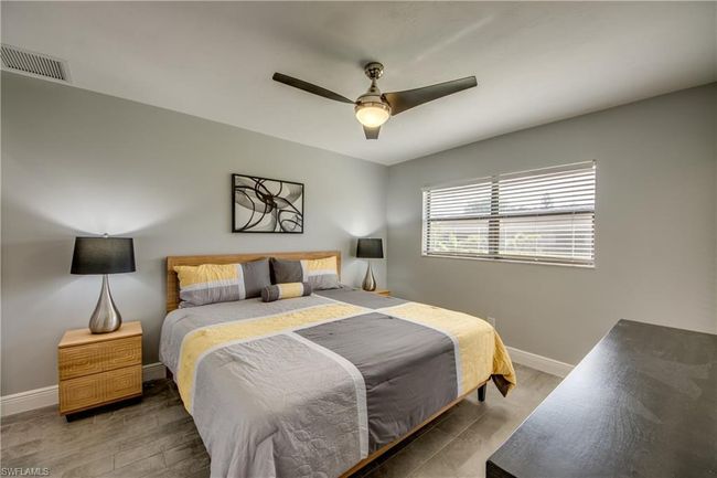 Bedroom with hardwood / wood-style floors and ceiling fan | Image 7