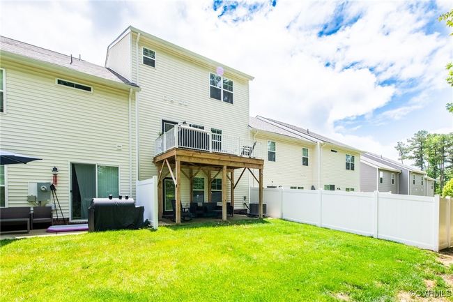 Rear view of house with an outdoor hangout area and a deck | Image 38