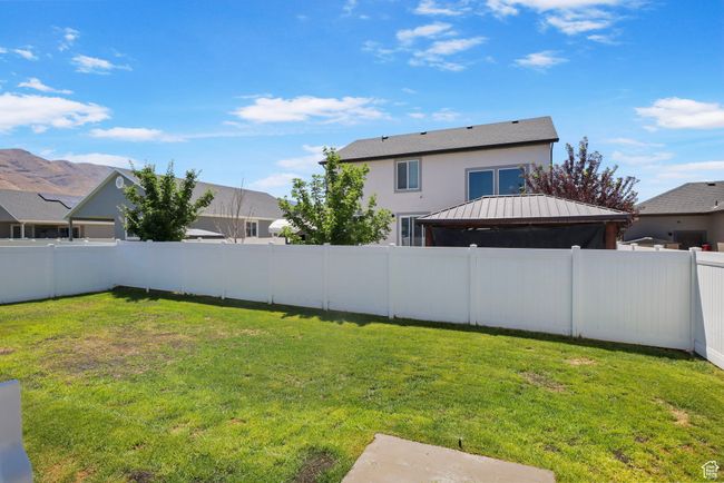 Fenced backyard with a gazebo | Image 22