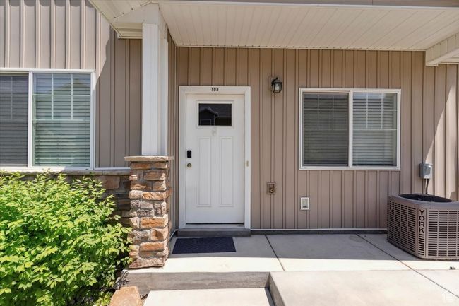 Property entrance featuring cooling unit and board and batten siding | Image 4