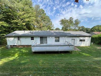 Back of property featuring a yard, cooling unit, and a deck | Image 3