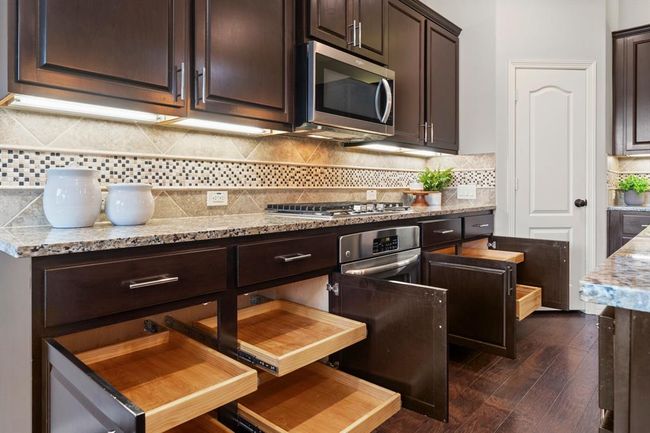 Custom pull-out drawers in lower cabinets offers smart and convenient storage to maximize space and organization | Image 16