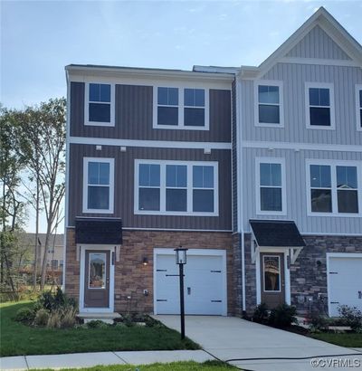 View of front of house with garage and a front lawn | Image 1