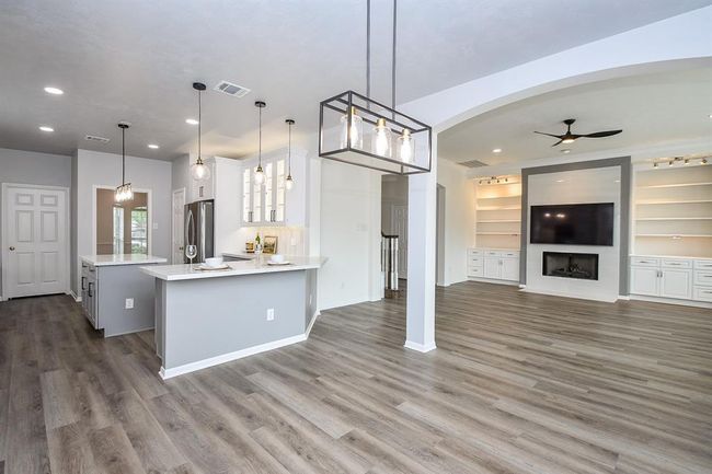Further in the hallway and you are in the heart of your home! Your new home's floors are luxury vinyl planks installed in 2021 and are waterproof, very low maintenance, and highly scratch resistant - perfect for your large dogs that usually scratch other hard floors, and kids that have spills and accidents. | Image 8